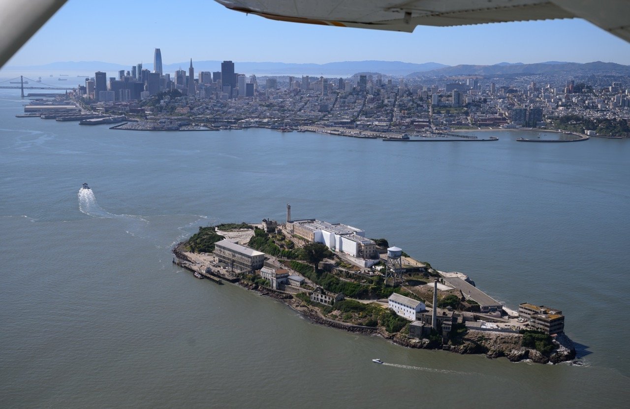 Aerial view of Alcatraz Island in front of the San Francisco skyline. Photo by Josh Edelson.