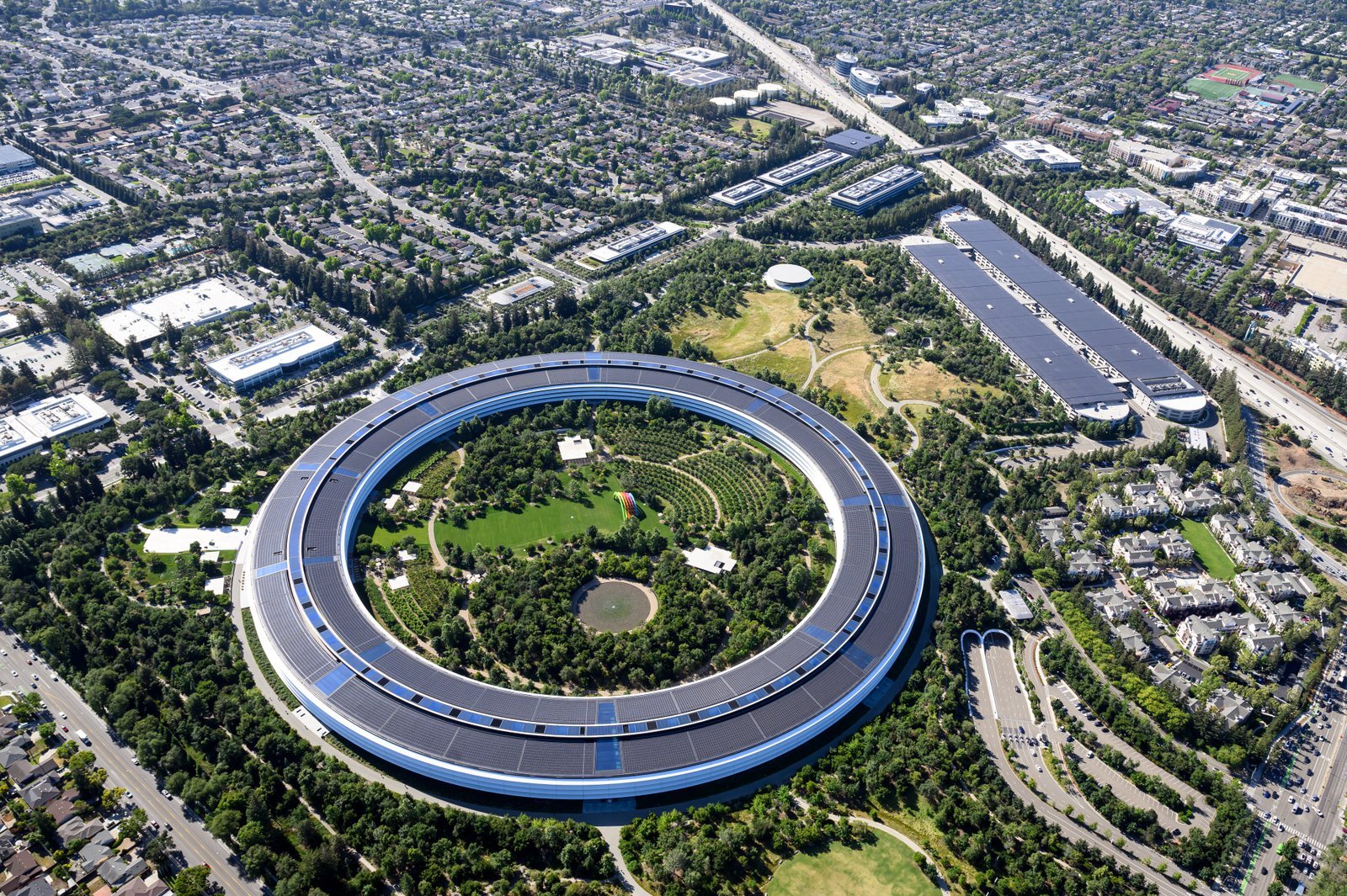 Apple Park surrounded by Cupertino's suburban landscape, seen from above. Photo by Josh Edelson.