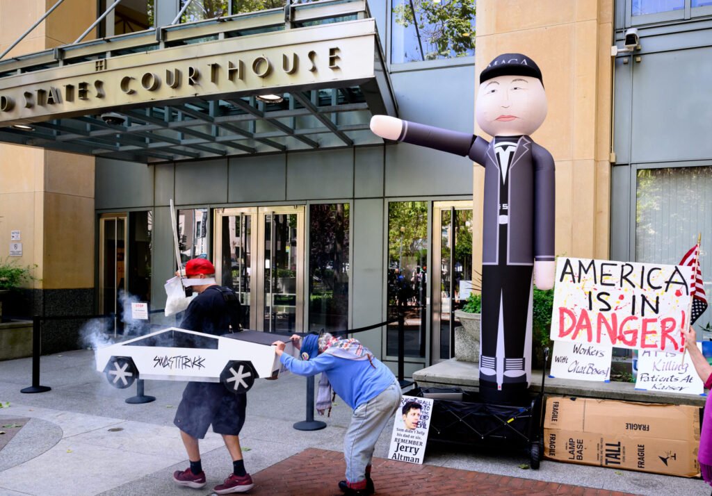 AI protesters chant outside Oakland federal courthouse during the Elon Musk vs. OpenAI trial — photo by Josh Edelson/AFP