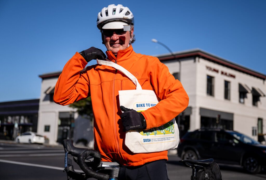 Cyclist with Bike to Wherever Days 2026 branded tote bag at Energizer Station in Napa — photo by Josh Edelson for MTC