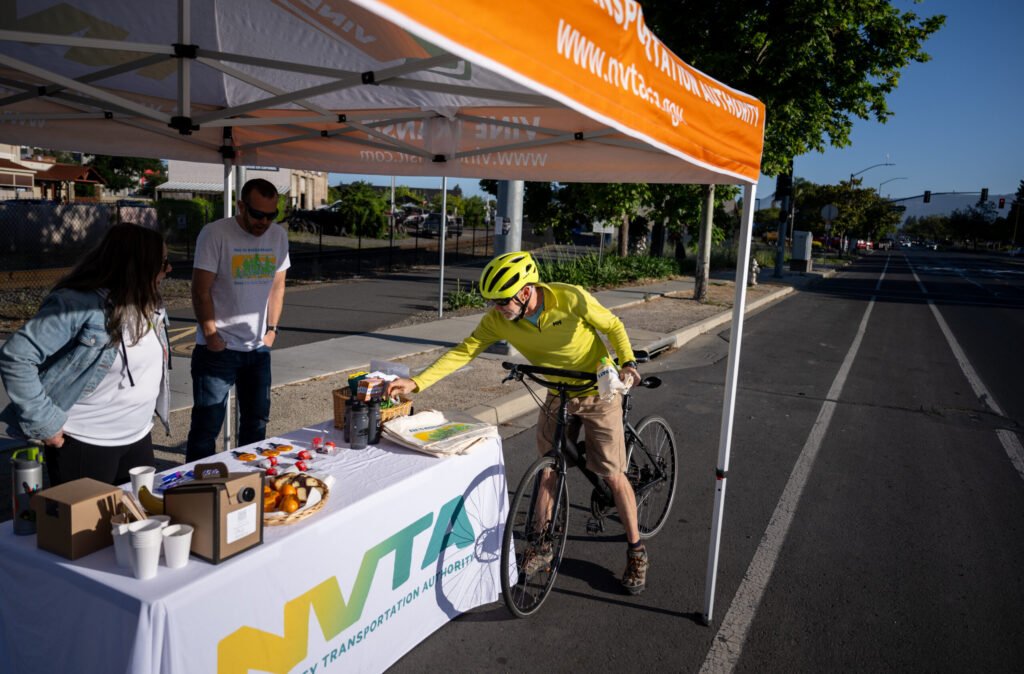 Cyclist stops at NVTA Energizer Station during Bike to Wherever Day in Napa — event photography by Josh Edelson for MTC/ABAG