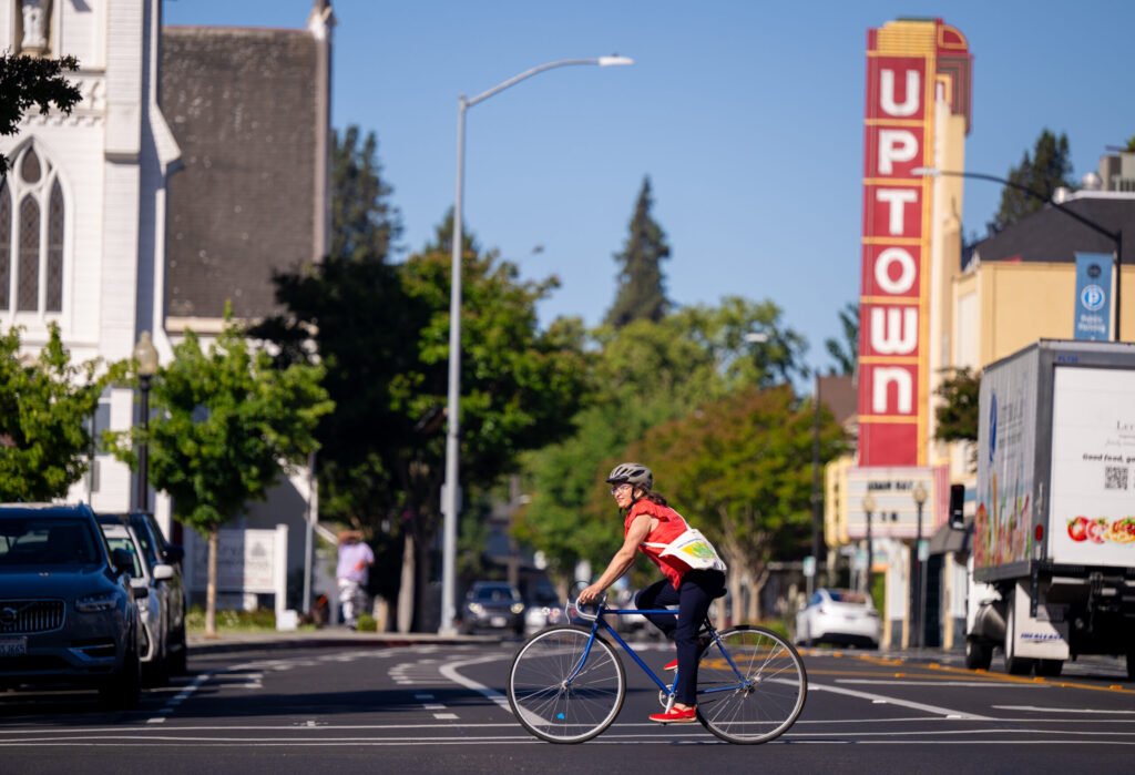 Cyclist rides through downtown Napa during Bike to Wherever Day 2026 — event photography by Josh Edelson for MTC