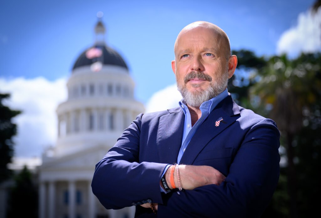 Steve Hilton, California governor candidate, arms crossed in front of the State Capitol dome