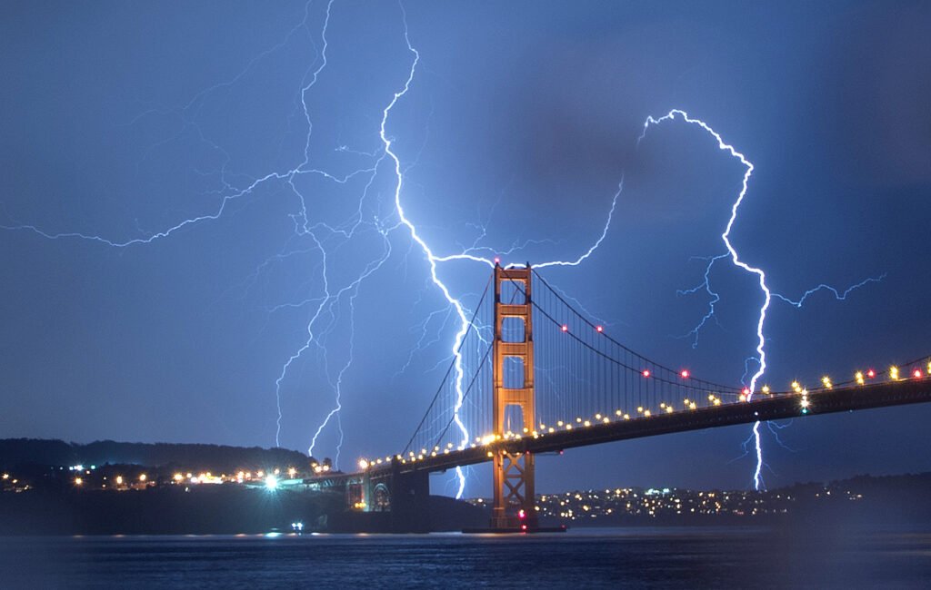 Lightning strikes around the Golden Gate Bridge during a rare San Francisco Bay Area thunderstorm, photo by Josh Edelson