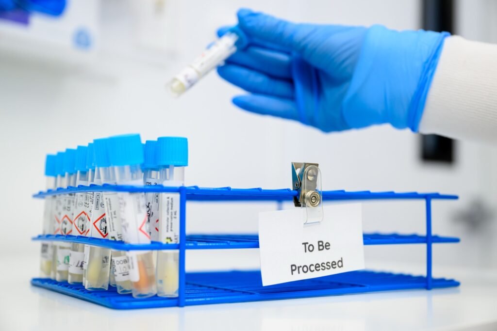 Gloved hands processing lab samples in a San Francisco life sciences lab
