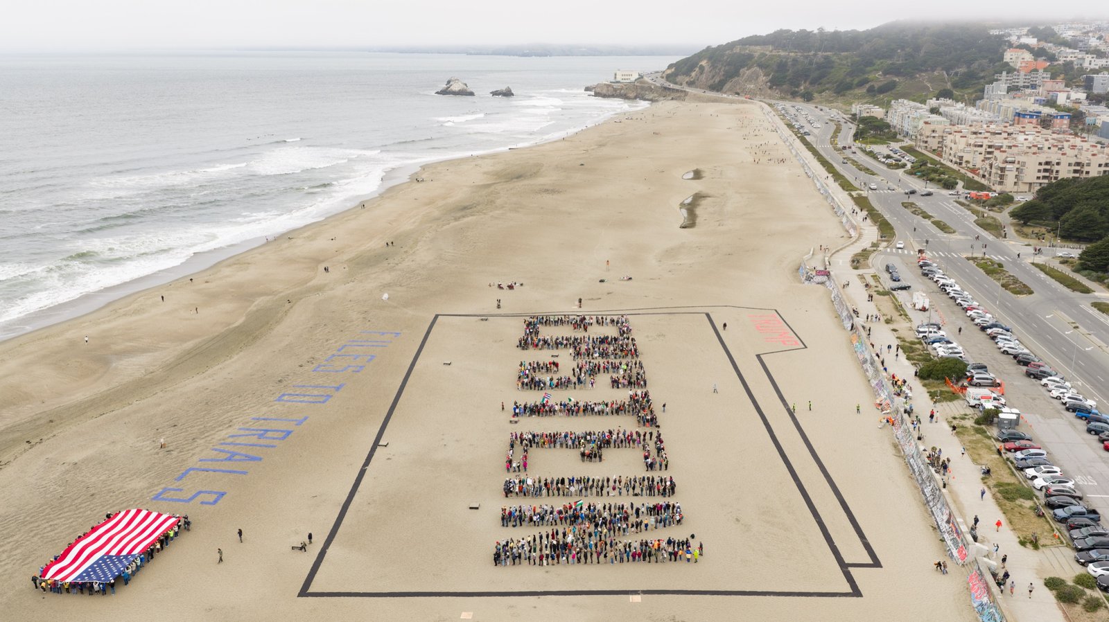 An aerial view over the Pacific shows the protest stretched along Ocean Beach in San Francisco. Aerial photo by Josh Edelson, on assignment for the San Francisco Chronicle.
