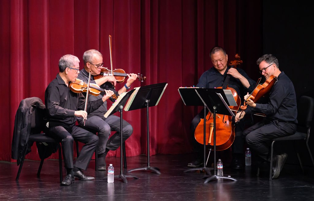 A string quartet performs on stage at the Stanford DLCL commencement ceremony