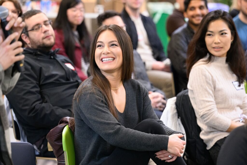 Engaged attendees watching a speaker at a corporate event, event photography by Josh Edelson