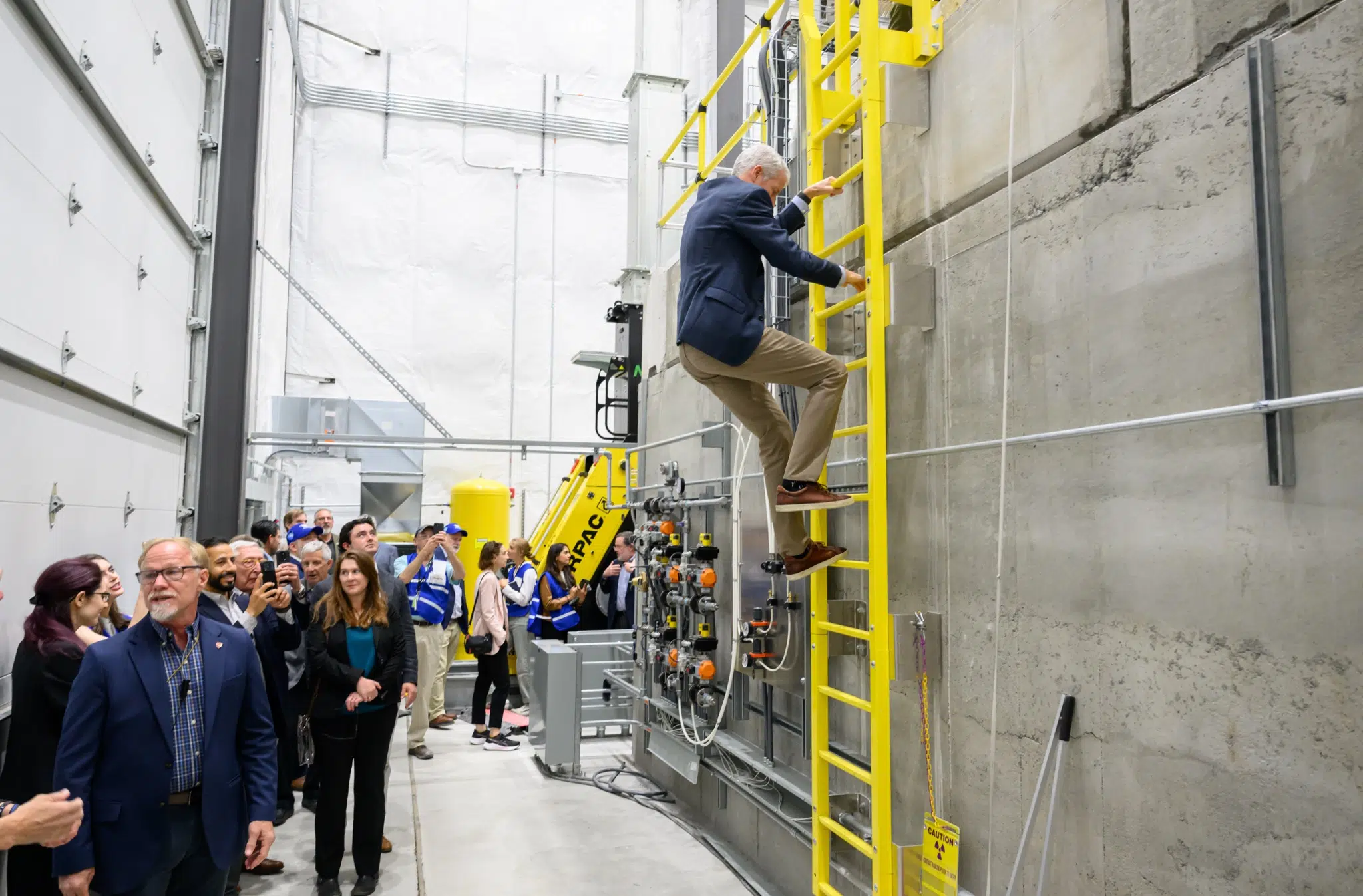 US Secretary of Energy Chris Wright climbs atop a nuclear reactor at the Aalo Atomics facility at Idaho National Laboratory