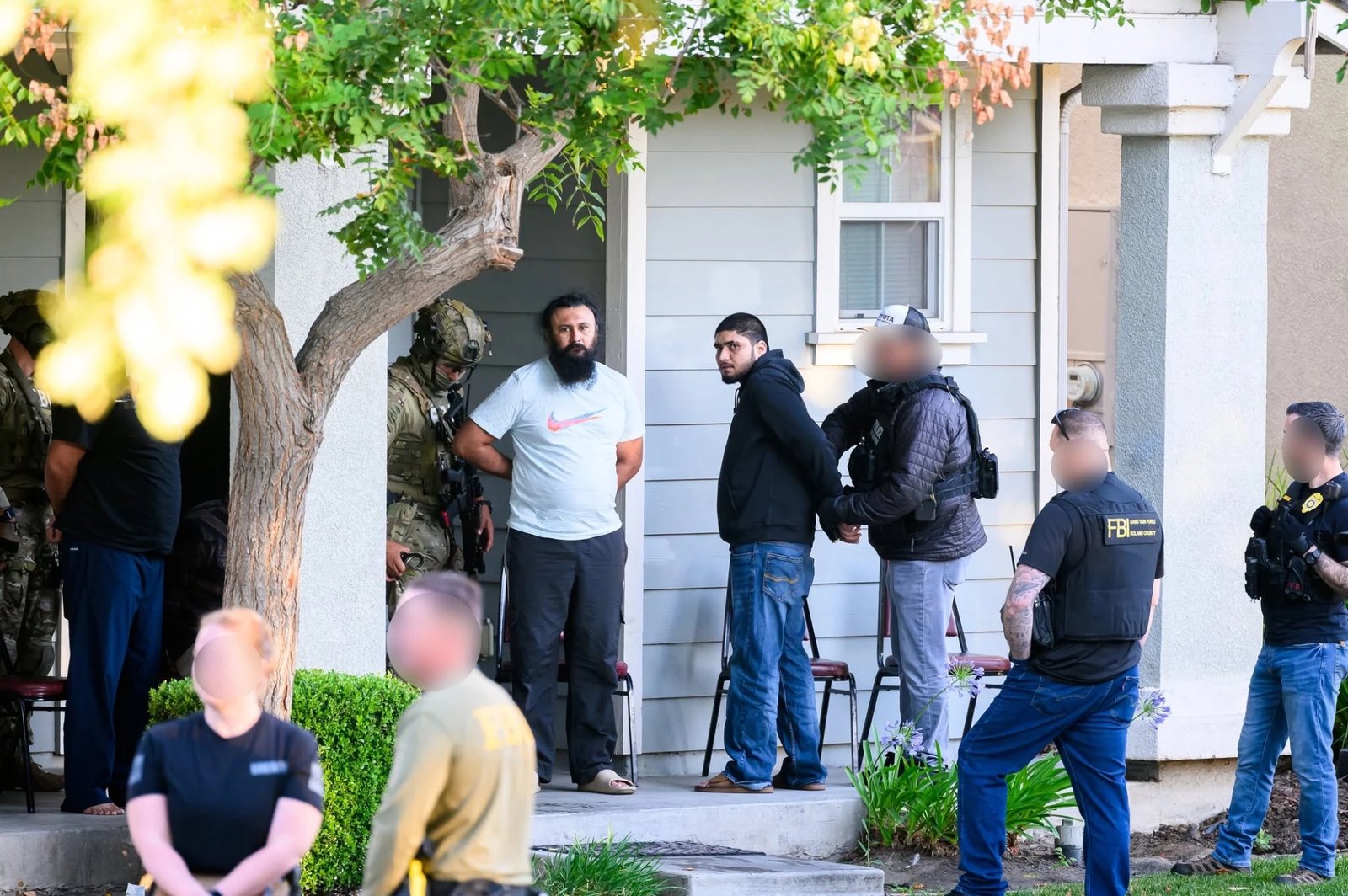FBI Gang Task Force officers process the scene.