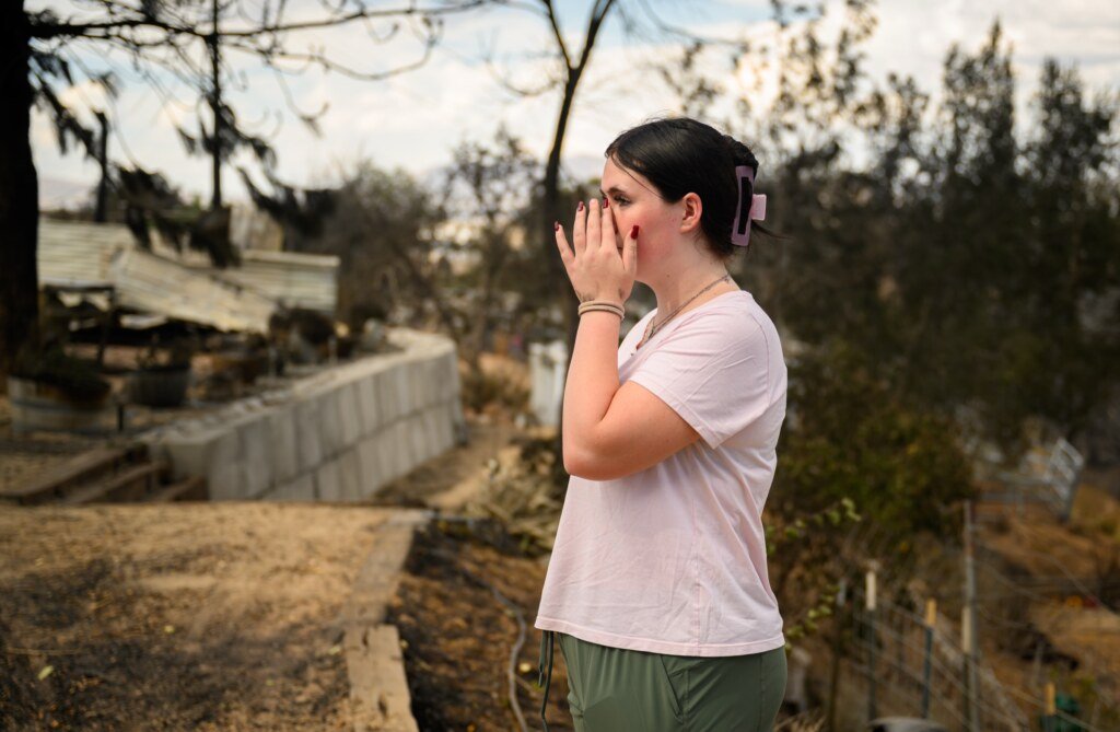 Resident Sydney Opperman weeps while viewing her burned home during the Hawk Fire in Reno, Nevada, August 24, 2026. (Josh Edelson / AFP)