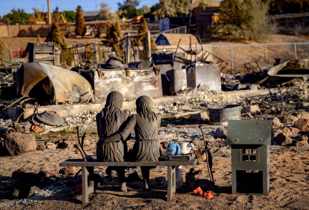 A statue of two people embracing remains at a burned home during the Hawk Fire in Reno, Nevada, August 24, 2026. (Josh Edelson / AFP)