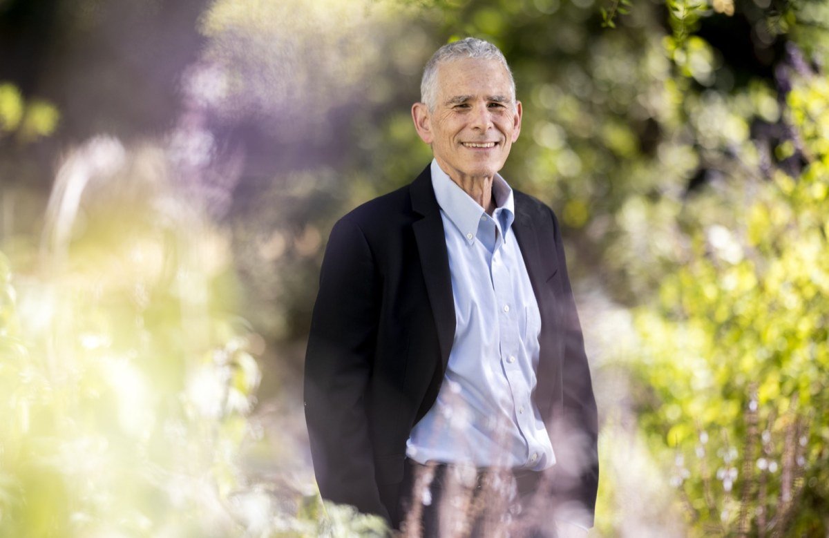 Joseph Bankman smiling in a garden at Stanford, editorial portrait photographed for the Los Angeles Times