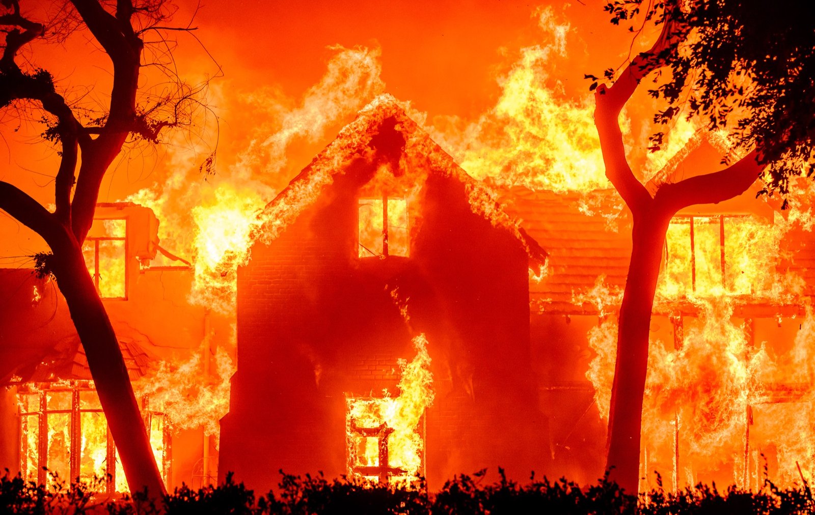 A home is completely engulfed in flames during the Eaton fire in the Altadena area of Los Angeles County, California on January 08, 2025. Multiple fast-moving wildfires broke out in Los Angeles county burning buildings and causing thousands to evacuate as "life threatening" winds whipped the region. Frightened residents abandoned their cars on one of the only roads in and out of the upscale Pacific Palisades area, fleeing on foot from the 770-acre (310-hectare) blaze engulfing an area crammed with multi-million dollar homes in the Santa Monica Mountains. (Josh Edelson / AFP)