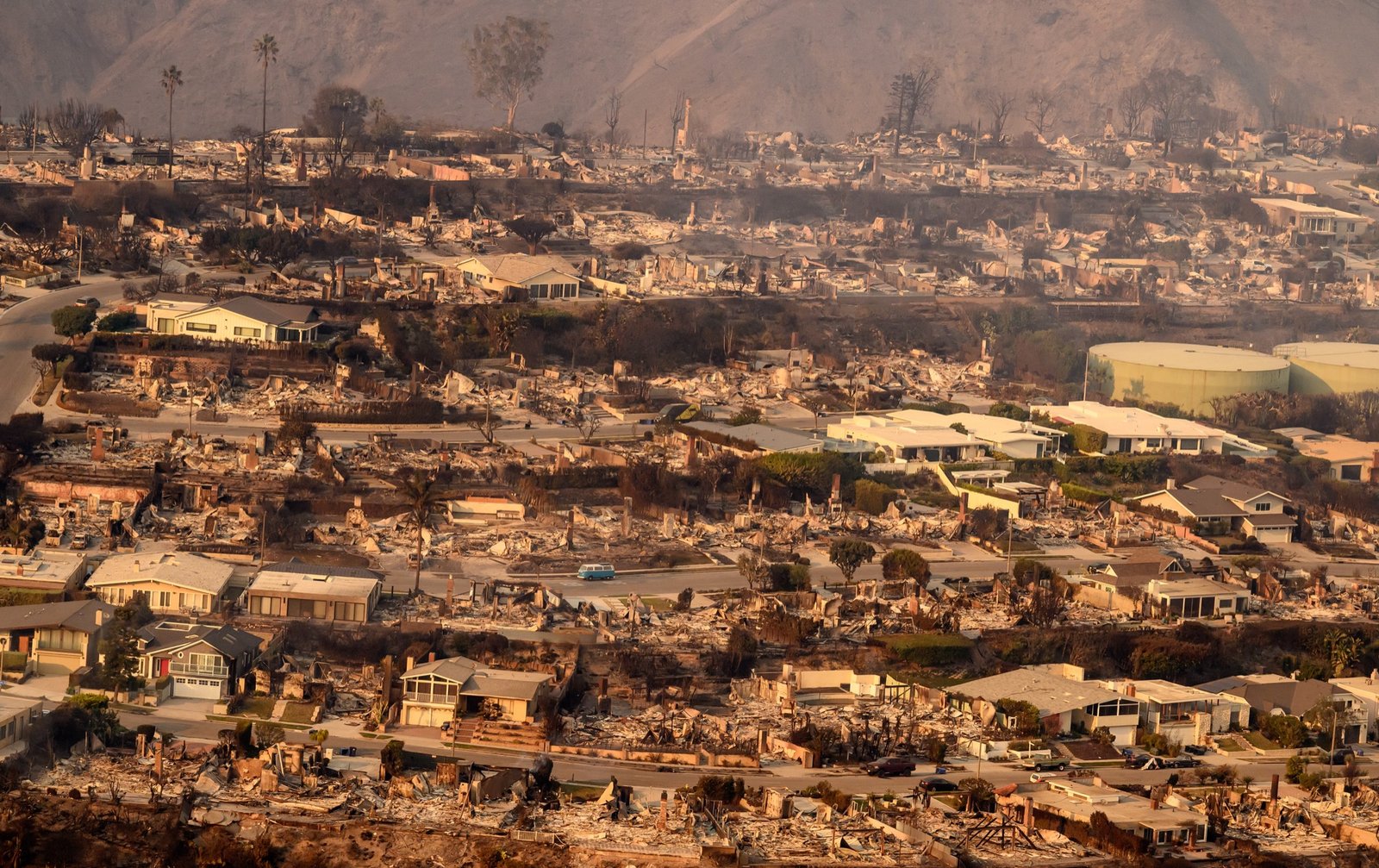 In this aerial view taken from a helicopter, homes burned from the Palisade fire smolder near the Malibu area of Los Angeles county, California on January 09, 2025. (Josh Edelson / AFP)