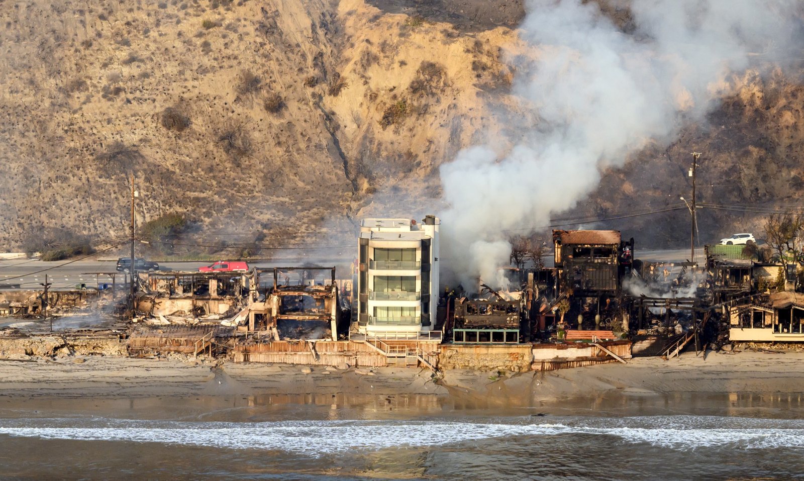In this aerial view taken from a helicopter, burned homes are seen from above during the Palisades fire in Los Angeles county, California on January 09, 2025. (Josh Edelson / AFP)