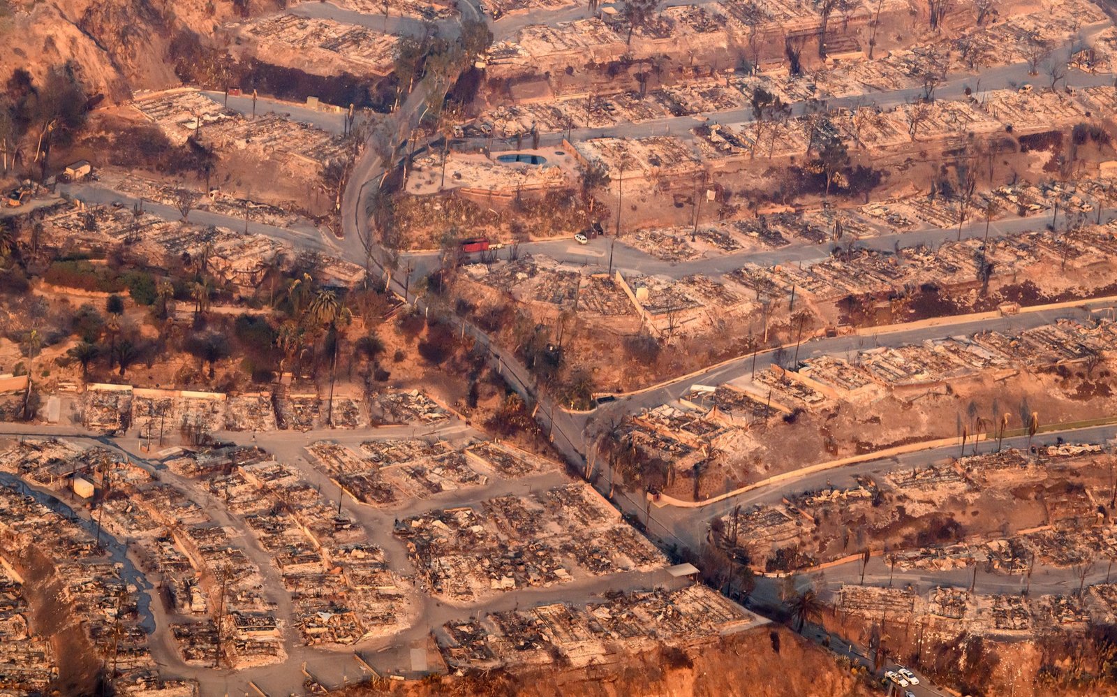 In this aerial view taken from a helicopter, burned homes are seen from above during the Palisades fire in the Pacific Palisades area of Los Angeles county, California on January 09, 2025. (Josh Edelson / AFP)