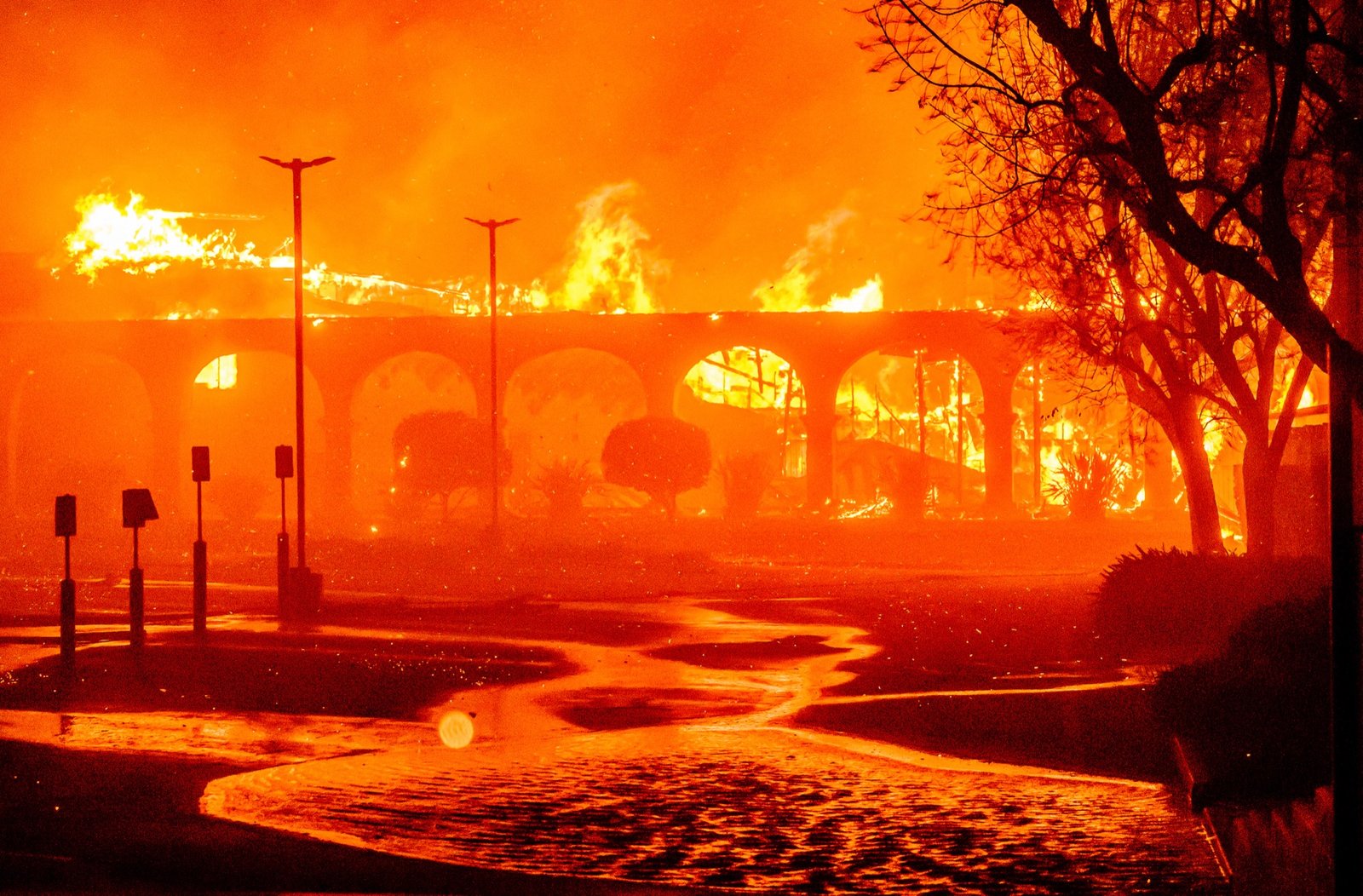 The Pasadena Jewish Temple & Center burns during the Eaton fire in Pasadena, California on January 07, 2025. Multiple fast-moving wildfires broke out in Los Angeles county burning buildings and causing thousands to evacuate as "life threatening" winds whipped the region. Frightened residents abandoned their cars on one of the only roads in and out of the upscale Pacific Palisades area, fleeing on foot from the 770-acre (310-hectare) blaze engulfing an area crammed with multi-million dollar homes in the Santa Monica Mountains. (Josh Edelson / AFP)