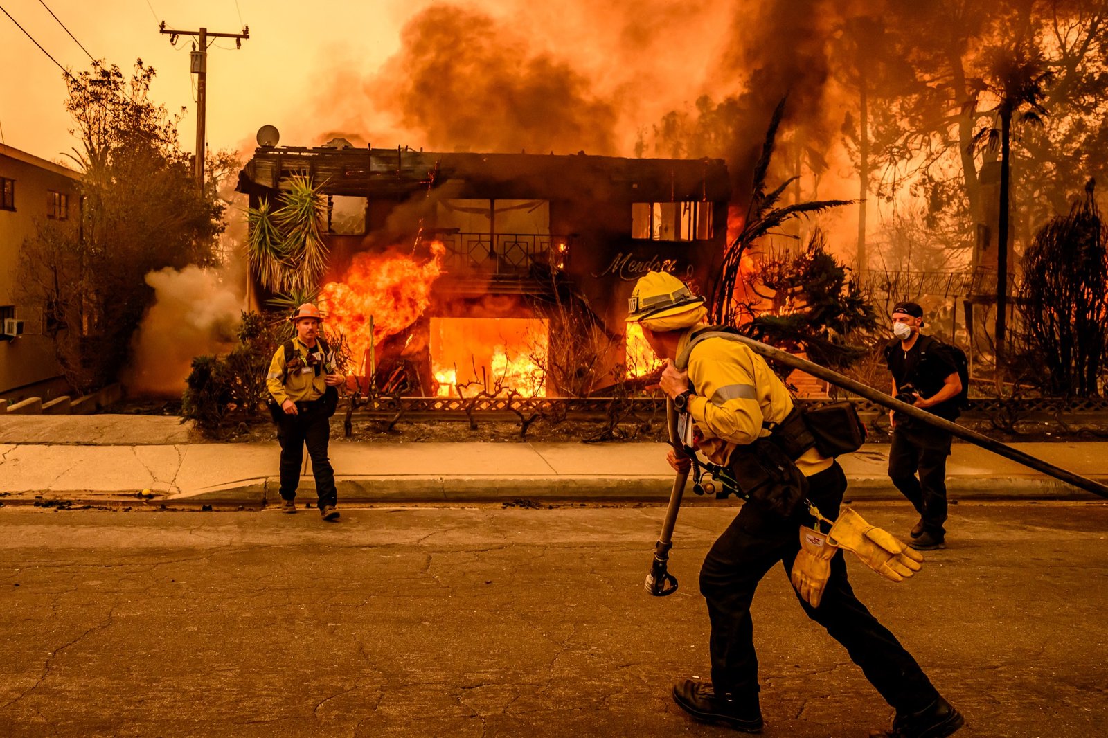 Firefighters work the scene as an apartment building burns during the Eaton fire in the Altadena area of Los Angeles county, California on January 08, 2025. (Josh Edelson / AFP)