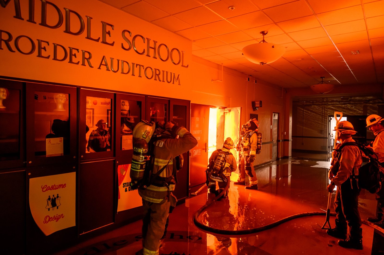 Firefighters prepare to fight flames from inside Eliot Arts Magnet middle school auditorium as the school burns during the Eaton fire in the Altadena area of Los Angeles county, California on January 08, 2025. (Josh Edelson / AFP)