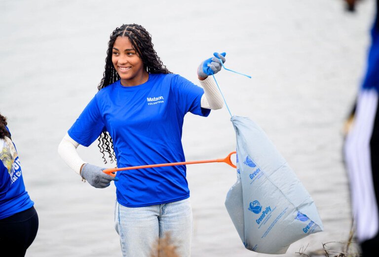 Matson employees volunteering on California Coastal Cleanup Day along the Oakland shoreline, corporate volunteer photography by Josh Edelson