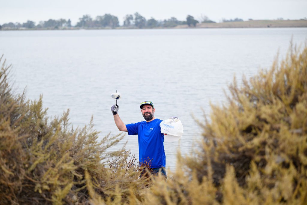 Matson employees volunteering on California Coastal Cleanup Day along the Oakland shoreline, corporate volunteer photography by Josh Edelson