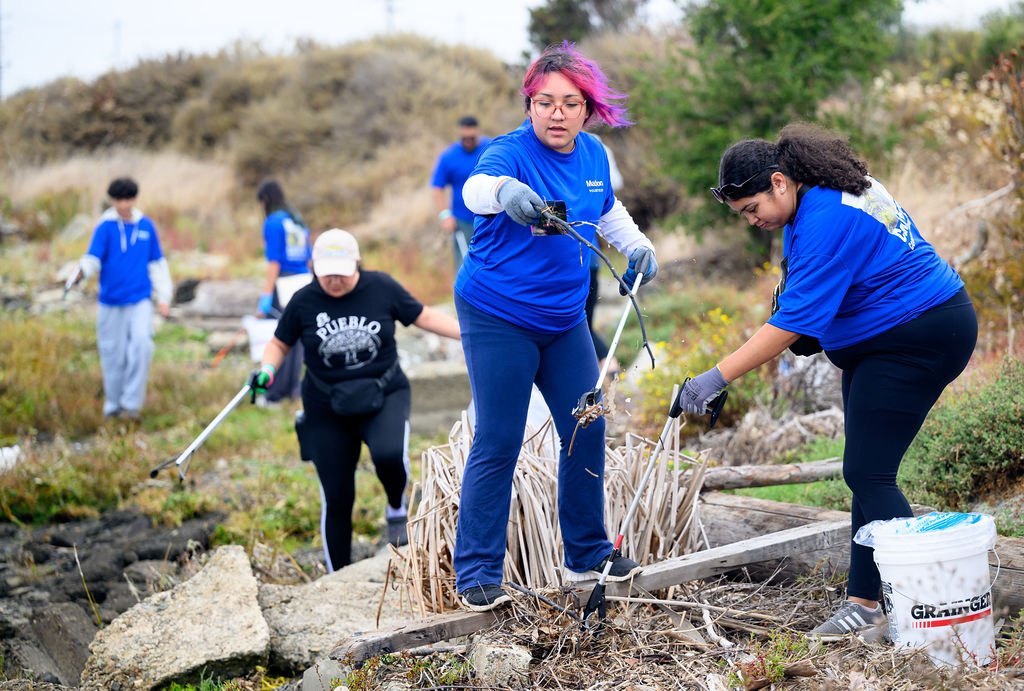 Matson employees volunteering on California Coastal Cleanup Day along the Oakland shoreline, corporate volunteer photography by Josh Edelson